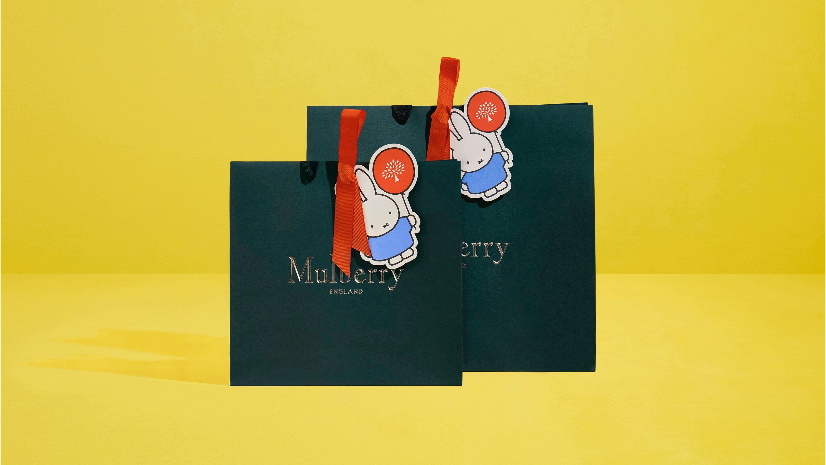two mulberry carrier bags with miffy lunar new year collection paper tags